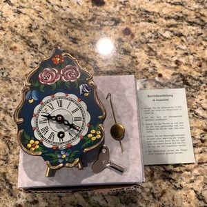 Mini German clock. Hand painted in Germany. New in box with key and pendulum.